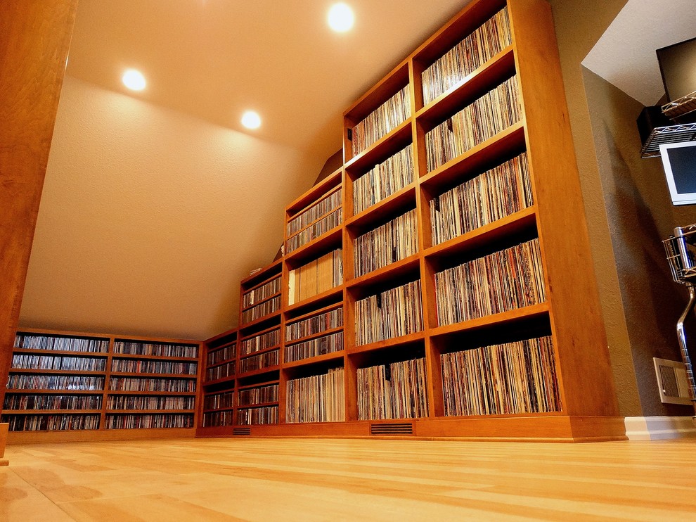 Inspiration for a large timeless light wood floor family room remodel in Milwaukee with a music area, beige walls, no fireplace and no tv