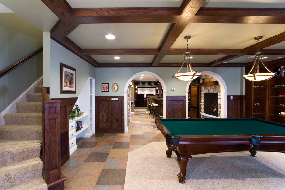 This is an example of a large classic open plan games room in Other with grey walls, ceramic flooring, orange floors, a standard fireplace, a stone fireplace surround and no tv.