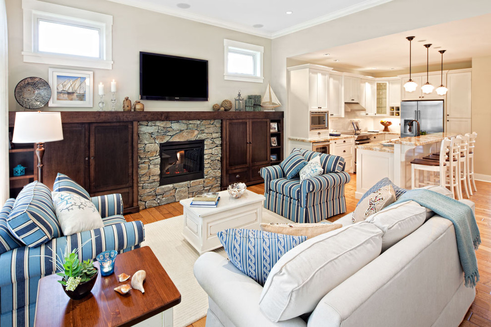 Photo of a beach style games room in Vancouver with grey walls and a stone fireplace surround.