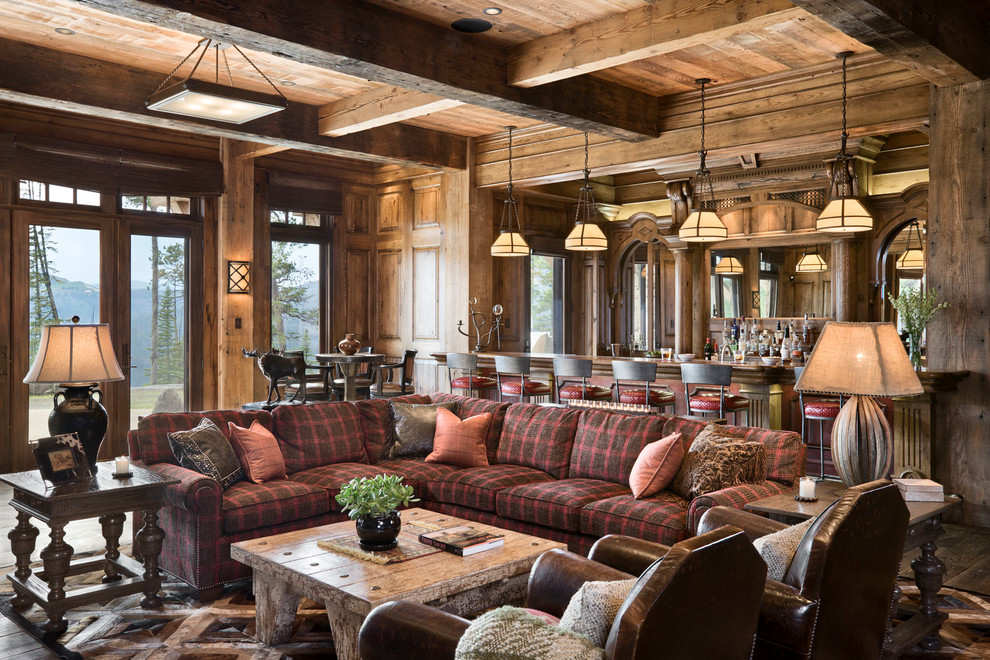 Example of a mountain style open concept family room design in Other with a bar, brown walls and no fireplace