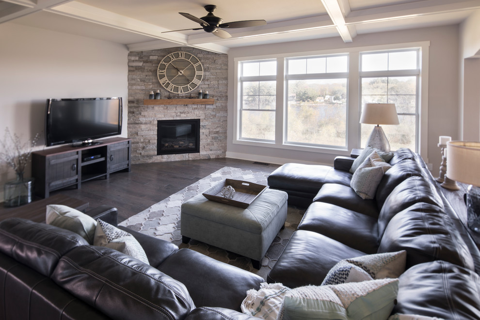 Inspiration for a large transitional open concept dark wood floor and brown floor family room remodel in Milwaukee with gray walls, a corner fireplace, a brick fireplace and a tv stand