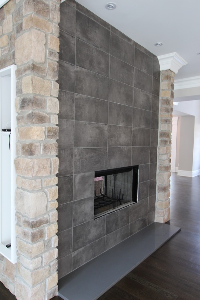 Inspiration for a contemporary dark wood floor family room remodel in New York with gray walls and a two-sided fireplace