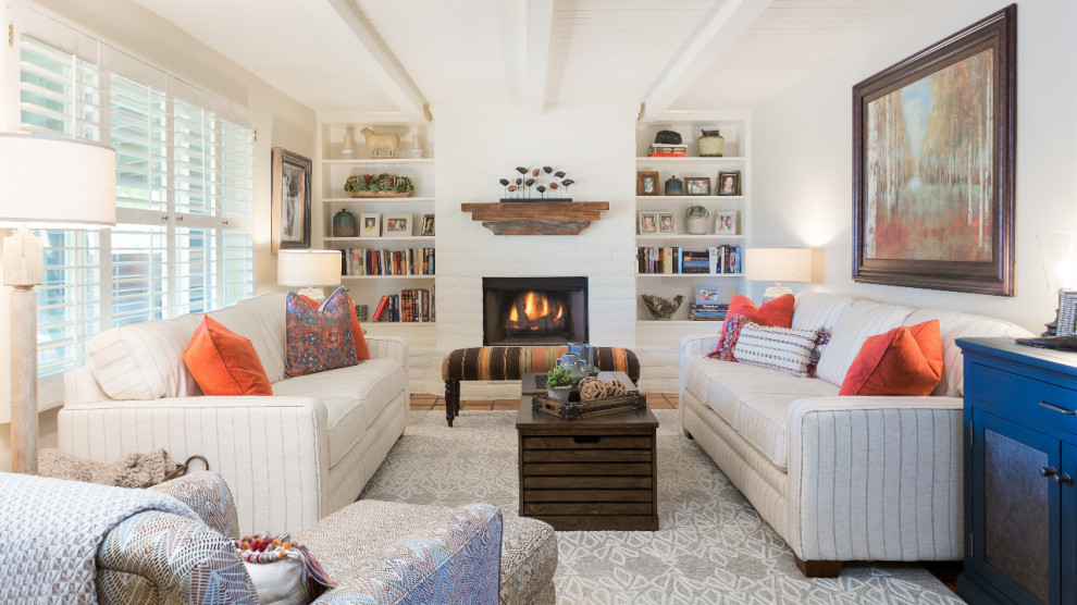 Family room - small eclectic open concept terra-cotta tile and orange floor family room idea in Phoenix with white walls, a standard fireplace, a brick fireplace and no tv