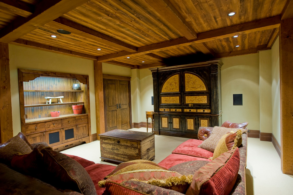 Family room - rustic enclosed carpeted family room idea in Calgary with beige walls, no fireplace and a concealed tv