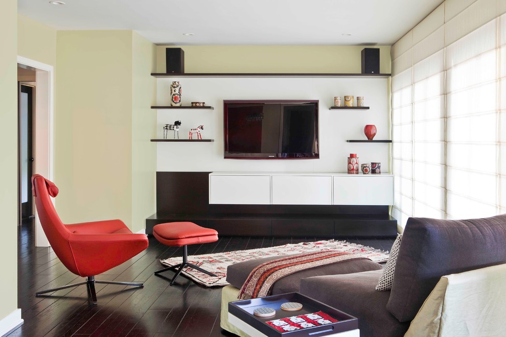 Family room - 1960s dark wood floor family room idea in Los Angeles with a wall-mounted tv and green walls
