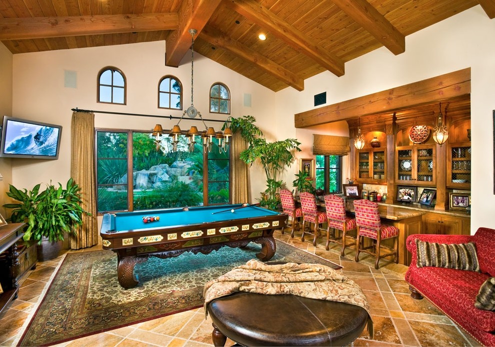 Game room - large traditional brown floor game room idea in San Diego with beige walls and a wall-mounted tv