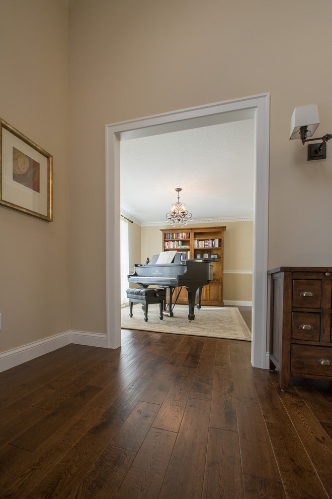 This is an example of a medium sized classic open plan games room in Minneapolis with a music area, beige walls and dark hardwood flooring.