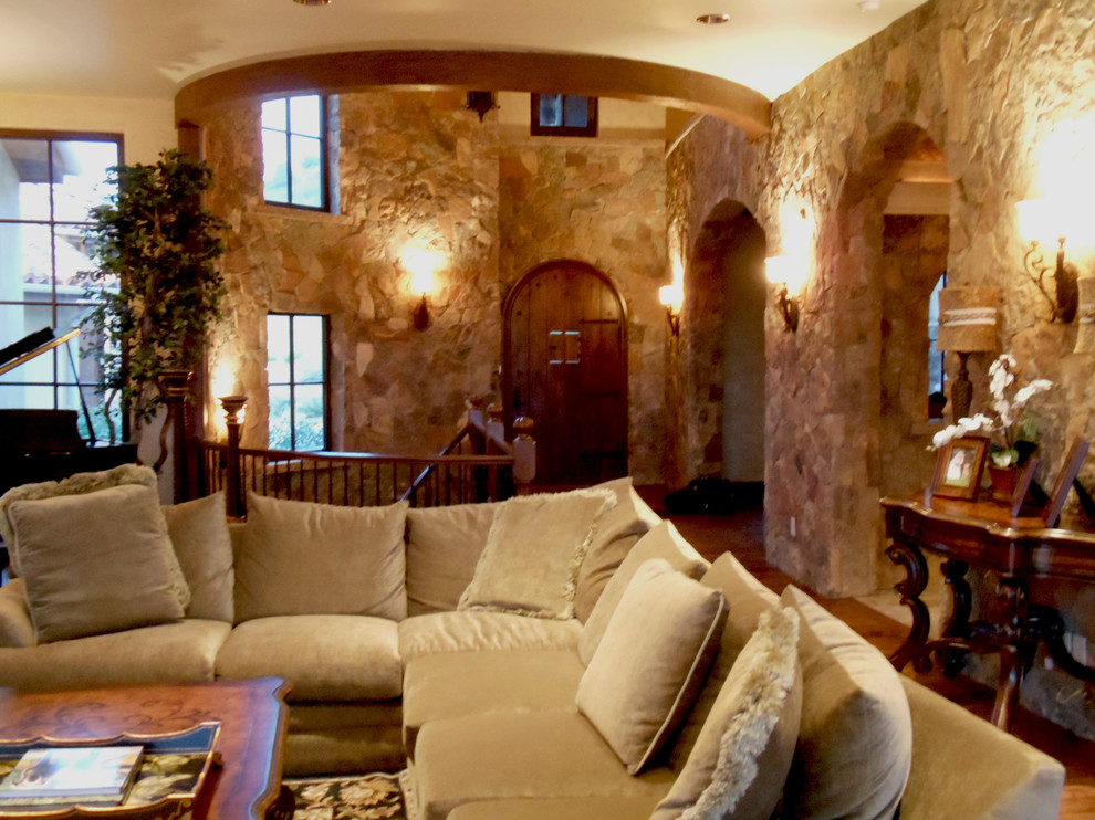 Example of a tuscan family room design in Denver