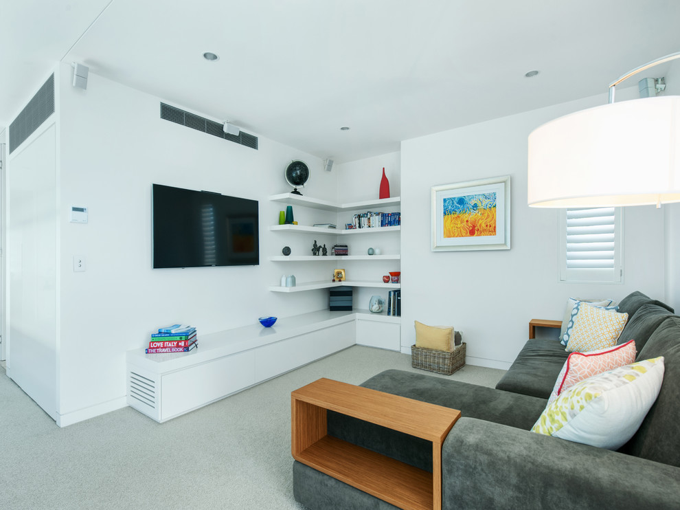 Immagine di un soggiorno moderno con moquette e TV a parete