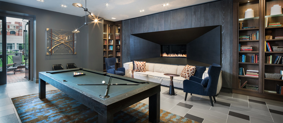 Design ideas for a large contemporary enclosed games room in Philadelphia with a game room, grey walls, porcelain flooring, a standard fireplace, a wooden fireplace surround and grey floors.