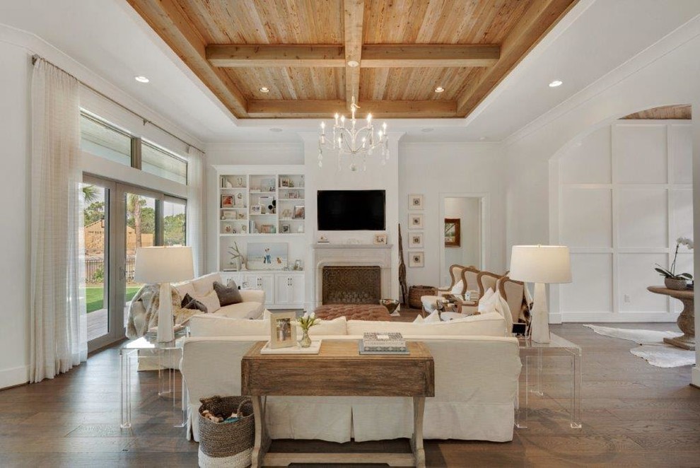 Family room - large farmhouse open concept medium tone wood floor family room idea in Miami with white walls, a standard fireplace, a stone fireplace and a wall-mounted tv