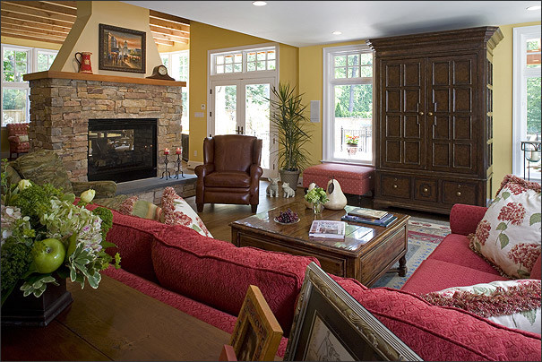 Example of a mid-sized classic open concept dark wood floor family room design in DC Metro with yellow walls, a two-sided fireplace, a stone fireplace and a concealed tv