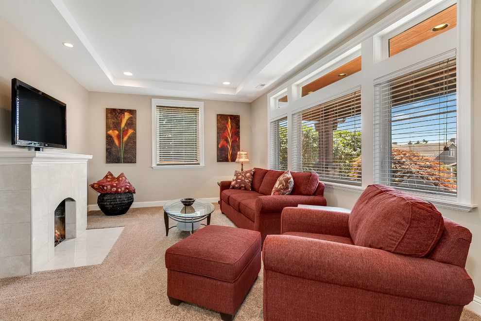 Inspiration for a mid-sized transitional enclosed carpeted and brown floor family room remodel in Seattle with beige walls, a standard fireplace, a tile fireplace and a tv stand