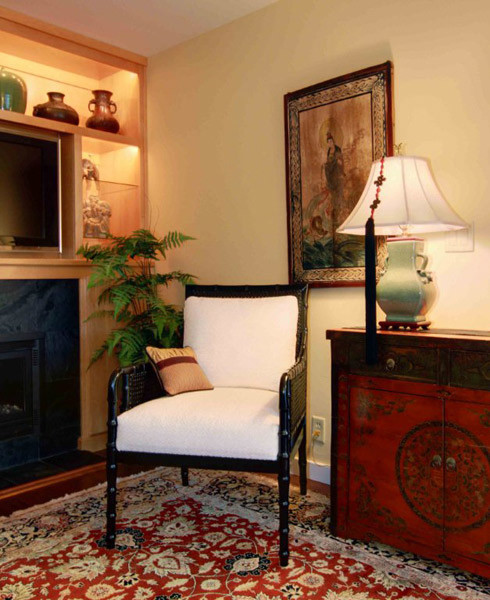 Inspiration for a mid-sized asian enclosed carpeted family room remodel in Sacramento with beige walls, a standard fireplace, a tile fireplace and a media wall
