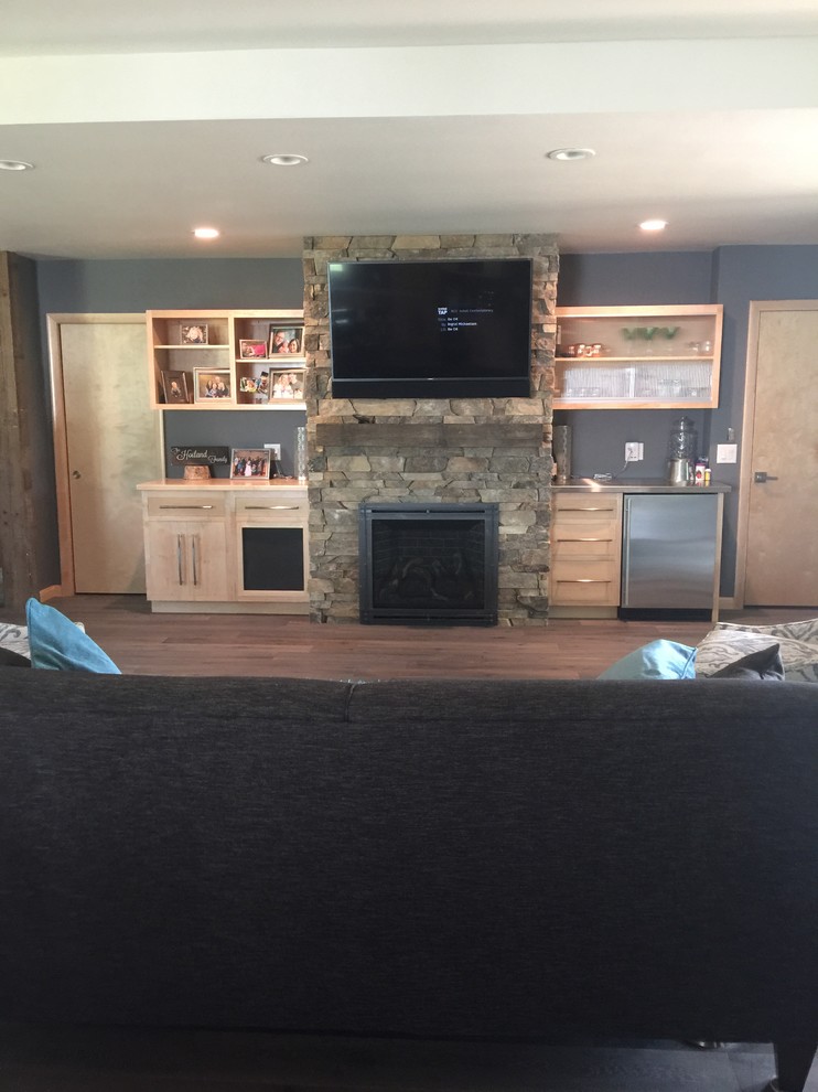 Photo of a large farmhouse open plan games room in Other with blue walls, light hardwood flooring, a standard fireplace, a metal fireplace surround and a wall mounted tv.