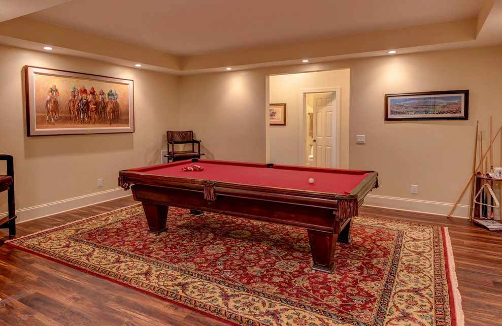 Example of a large classic open concept dark wood floor and brown floor game room design in Nashville with beige walls, no fireplace and no tv