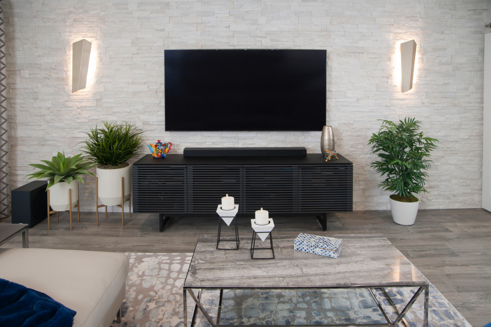 Foto di un soggiorno minimalista di medie dimensioni e aperto con pareti grigie, pavimento in laminato, TV a parete e pavimento grigio