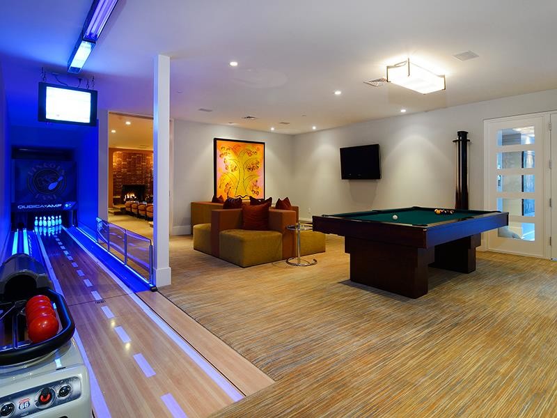 Inspiration for a huge timeless open concept carpeted game room remodel in New York with a wall-mounted tv, white walls and no fireplace