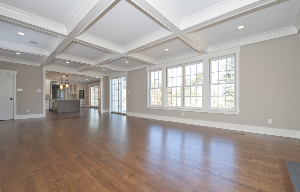 Inspiration for a large traditional open plan games room in Philadelphia with beige walls, medium hardwood flooring, a standard fireplace, a stone fireplace surround and a built-in media unit.