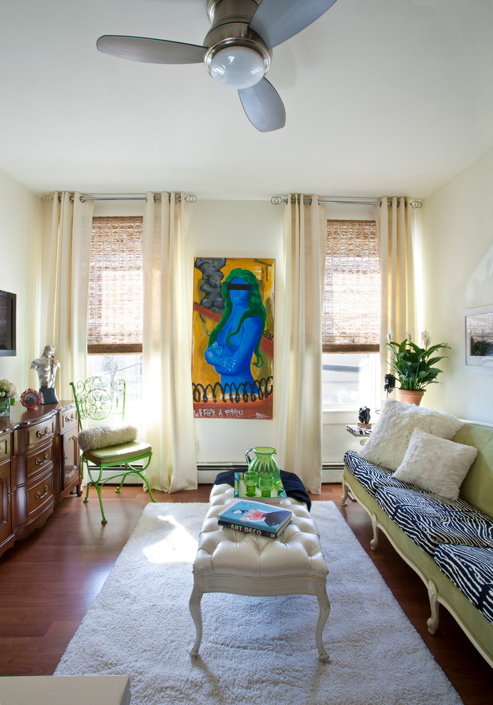 Example of a small eclectic enclosed medium tone wood floor family room design in New York with a wall-mounted tv