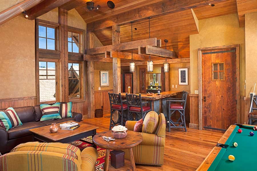 Inspiration for a mid-sized rustic open concept light wood floor and brown floor game room remodel in Other with beige walls and no fireplace