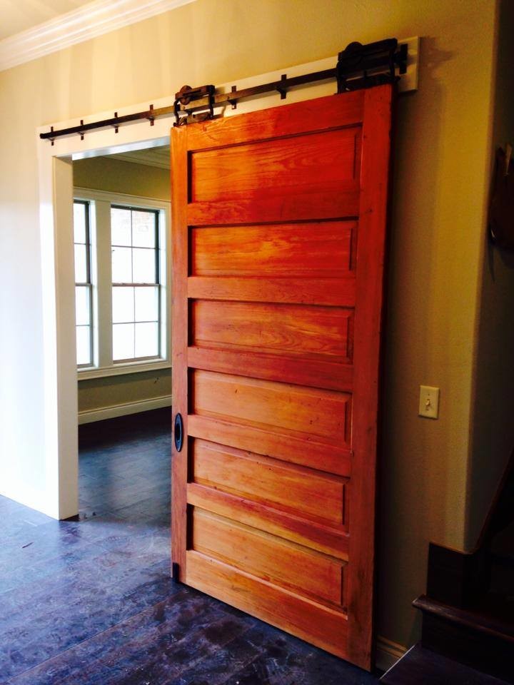 Restored farmhouse door with original antique pocket door sliders