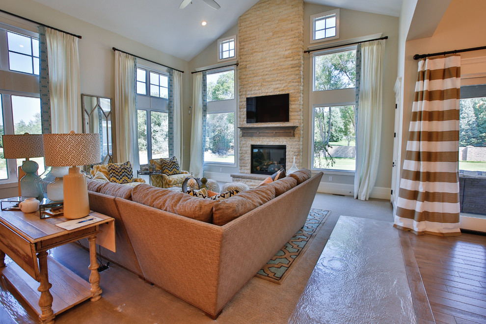 Large classic open plan games room in Salt Lake City with grey walls, carpet, a standard fireplace, a stone fireplace surround and a wall mounted tv.