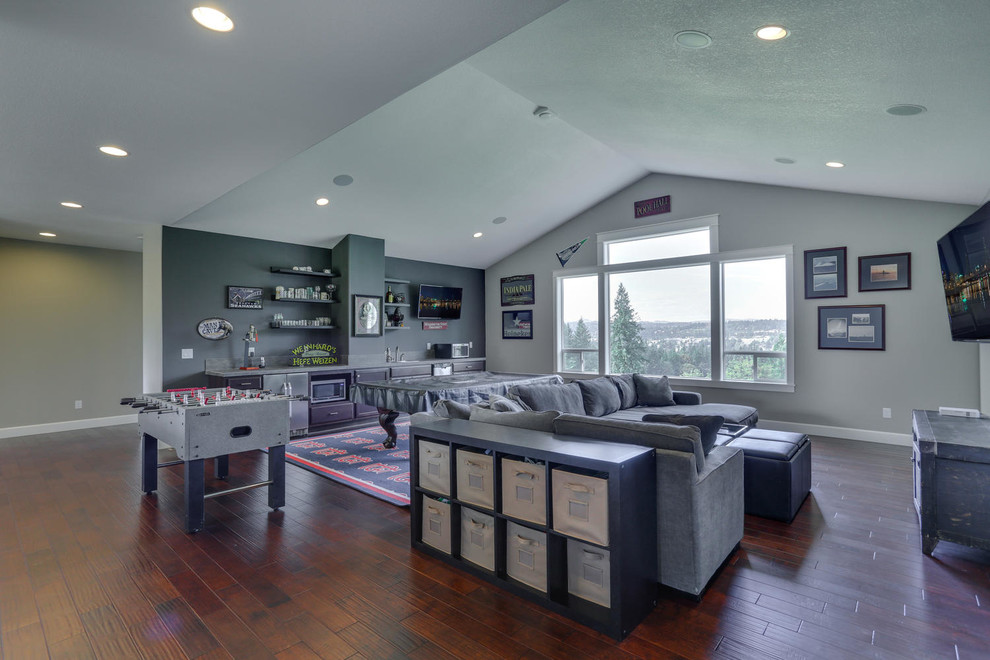 Family room - large craftsman loft-style medium tone wood floor family room idea in Portland with gray walls
