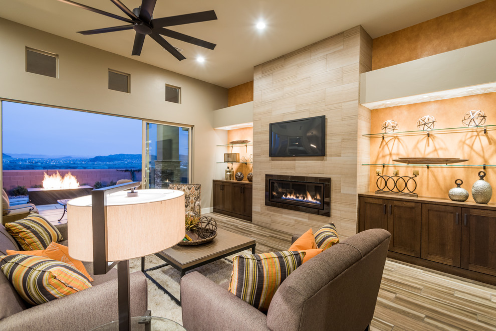 Medium sized classic open plan games room in Salt Lake City with beige walls, porcelain flooring, a ribbon fireplace, a tiled fireplace surround and a wall mounted tv.