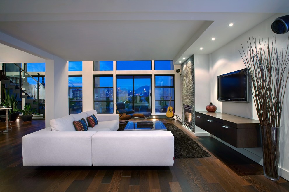 Example of a large trendy open concept dark wood floor family room design in Vancouver with a standard fireplace and a wall-mounted tv