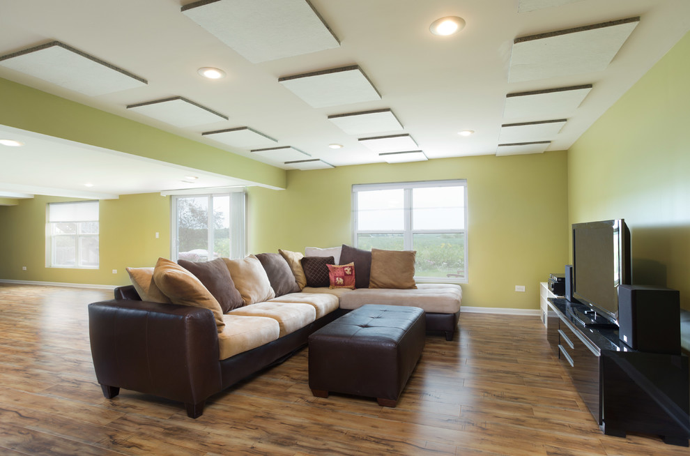 Example of a large trendy open concept medium tone wood floor family room design in Chicago with green walls, no fireplace and a tv stand