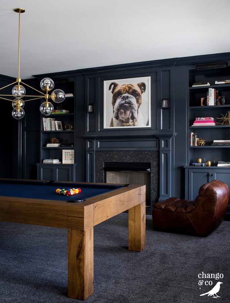 Photo of an expansive traditional open plan games room in New York with a game room, blue walls, dark hardwood flooring, a standard fireplace, a stone fireplace surround, a wall mounted tv and brown floors.