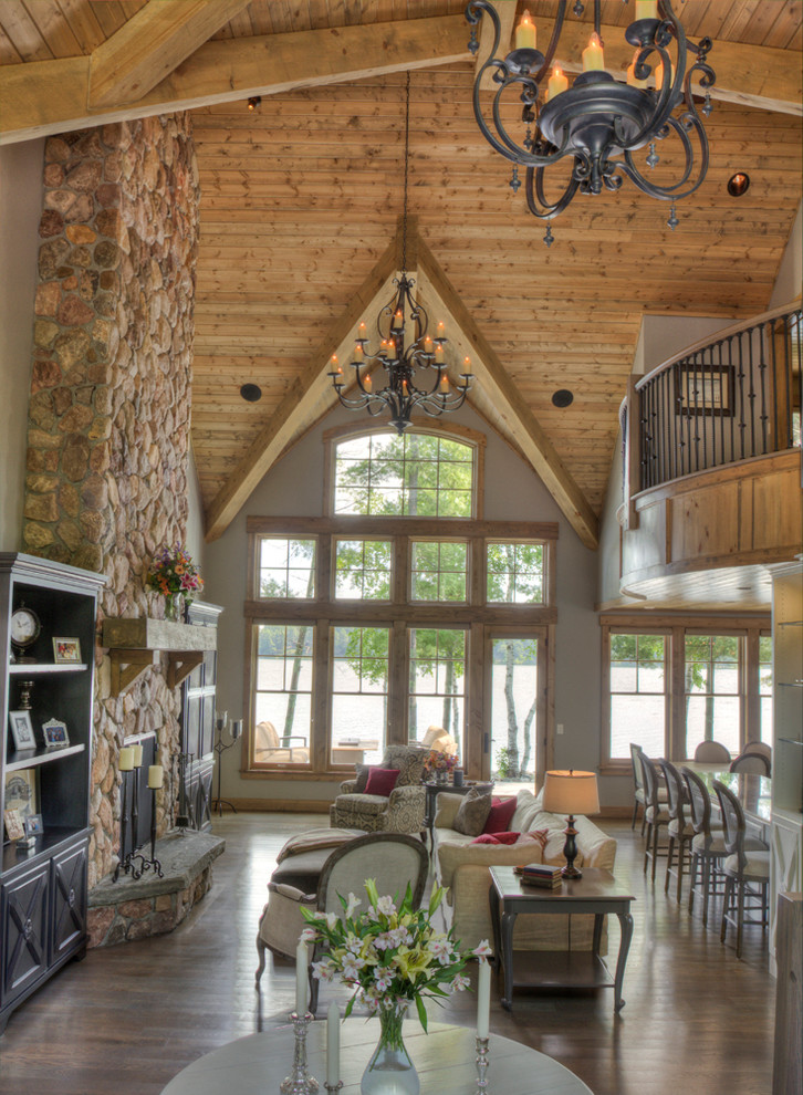 Mountain style family room photo in Minneapolis with a standard fireplace and a stone fireplace