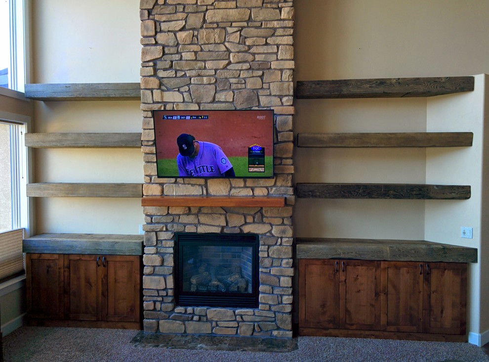 This is an example of a rustic games room in Seattle with carpet, a standard fireplace and a wooden fireplace surround.