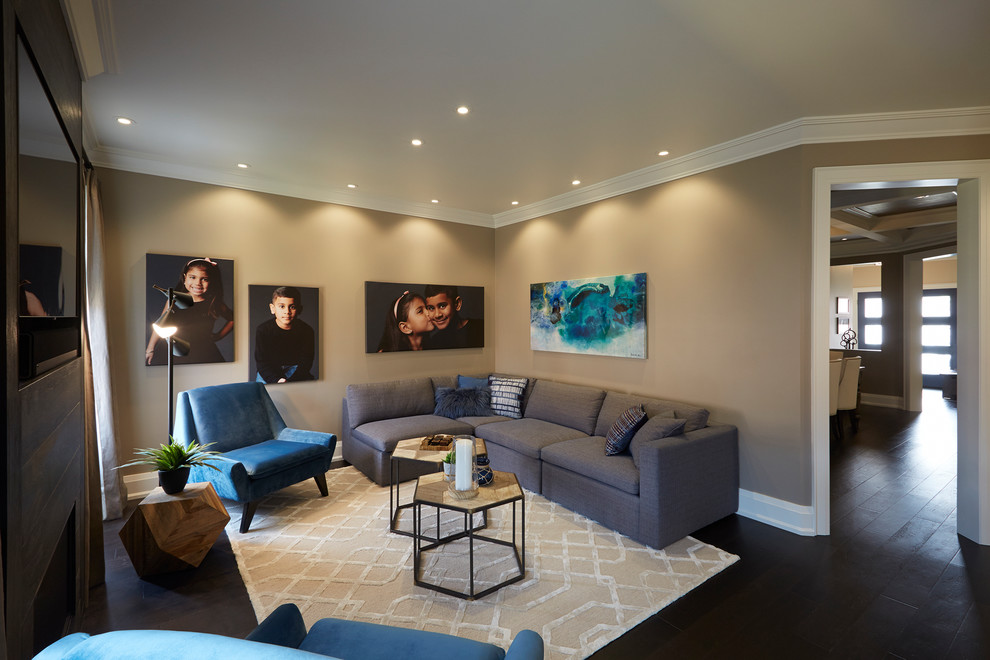Medium sized contemporary open plan games room in Toronto with dark hardwood flooring, brown walls, a standard fireplace, a tiled fireplace surround, a wall mounted tv and brown floors.