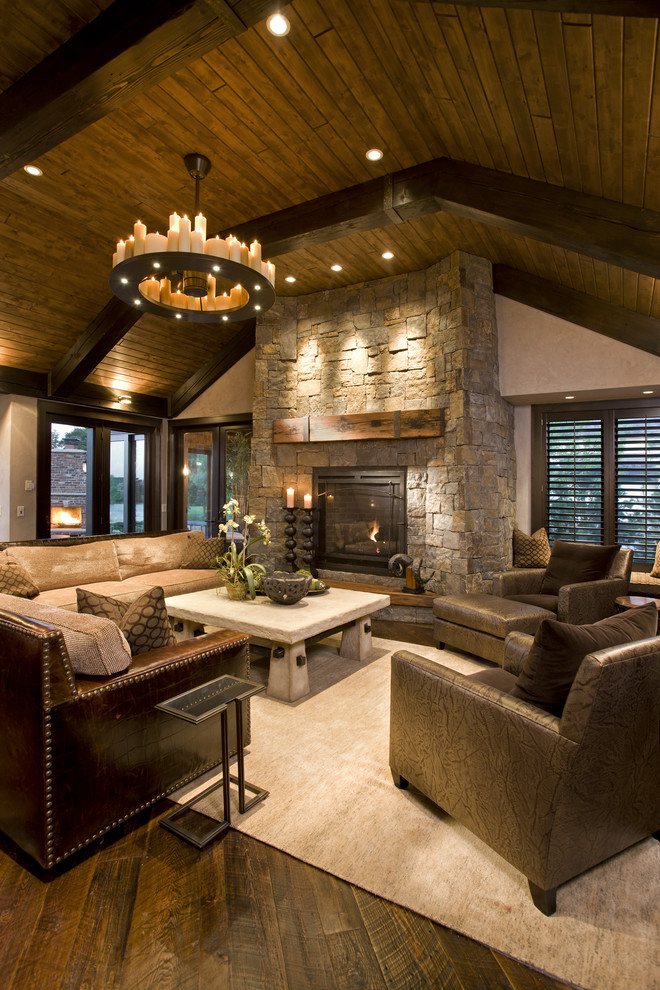 Mountain style family room photo in Minneapolis with a stone fireplace