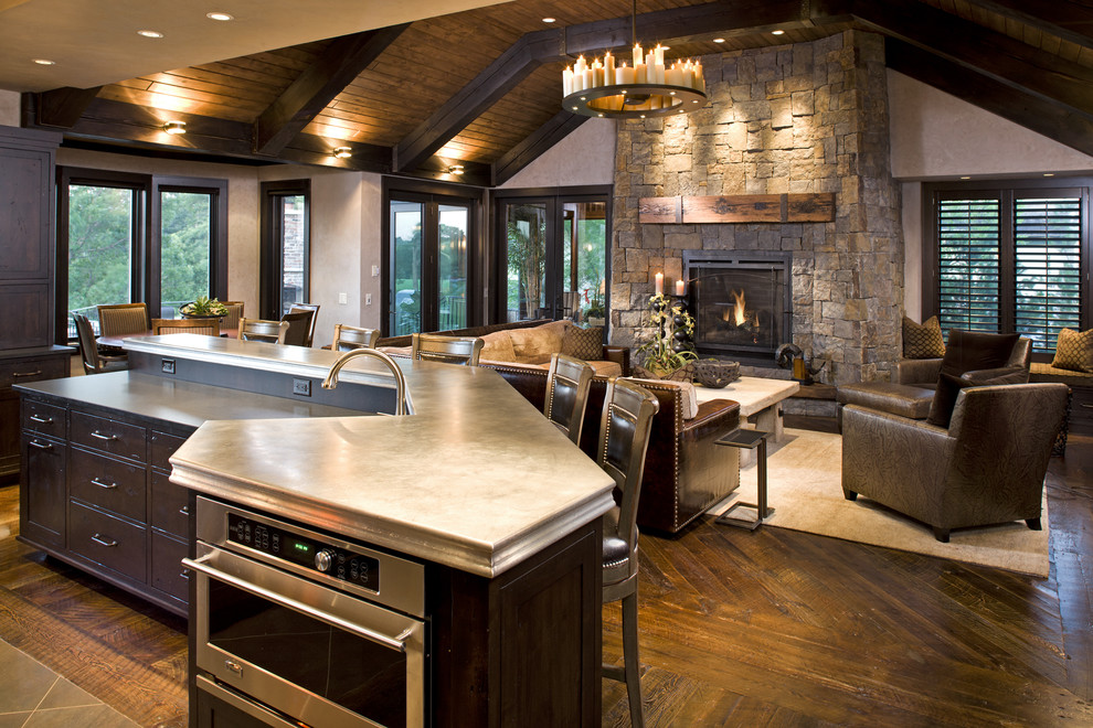 Inspiration for a rustic family room remodel in Minneapolis with a stone fireplace