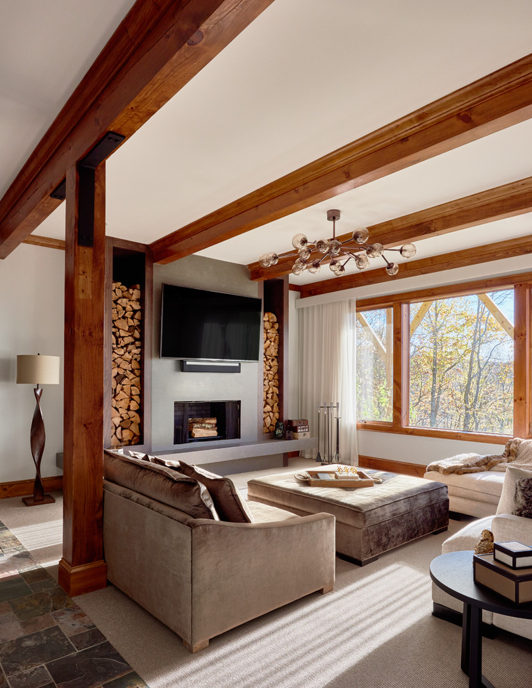 Inspiration for a large rustic enclosed carpeted family room remodel in Charlotte with white walls, a standard fireplace, a plaster fireplace and a wall-mounted tv