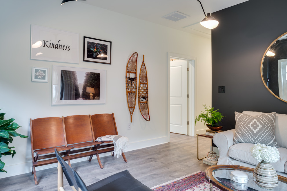 Inspiration for a mid-sized transitional enclosed light wood floor and beige floor family room remodel in Atlanta with black walls, no fireplace and no tv