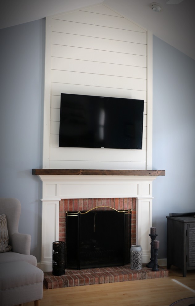 This is an example of a rural games room in Chicago with a standard fireplace and a wooden fireplace surround.