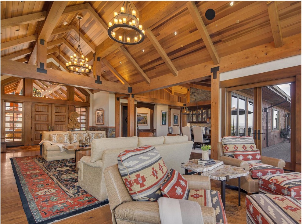Large rustic open plan games room in Seattle with a standard fireplace, a stone fireplace surround and no tv.