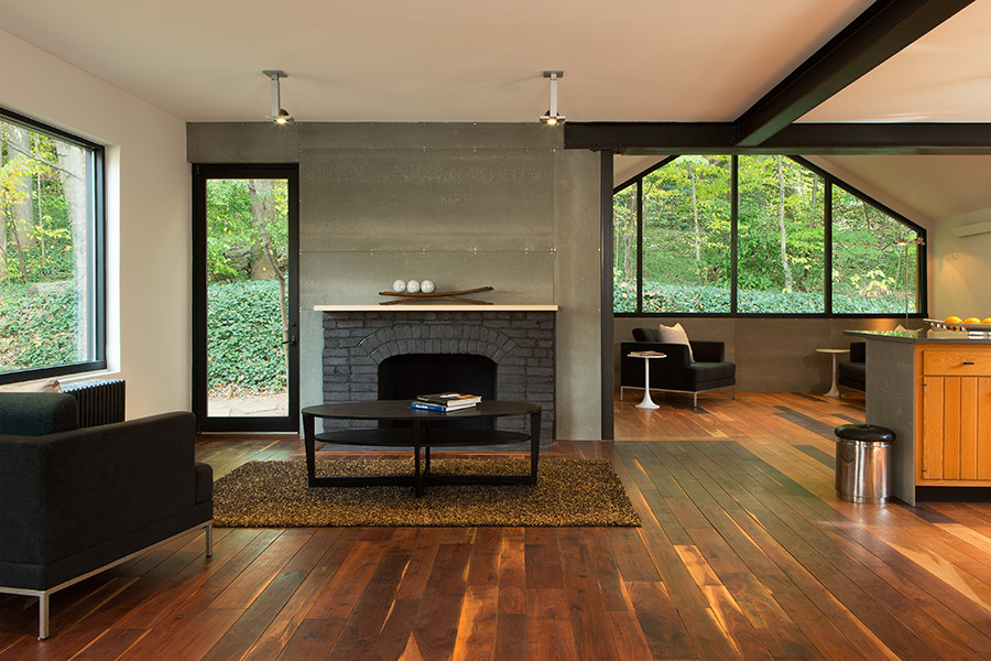 Inspiration for a modern open concept dark wood floor family room remodel in DC Metro with a standard fireplace