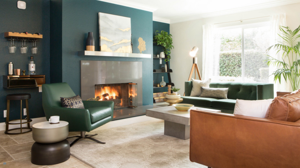 Example of a small trendy enclosed travertine floor and brown floor family room design in Orange County with green walls, no tv and a standard fireplace