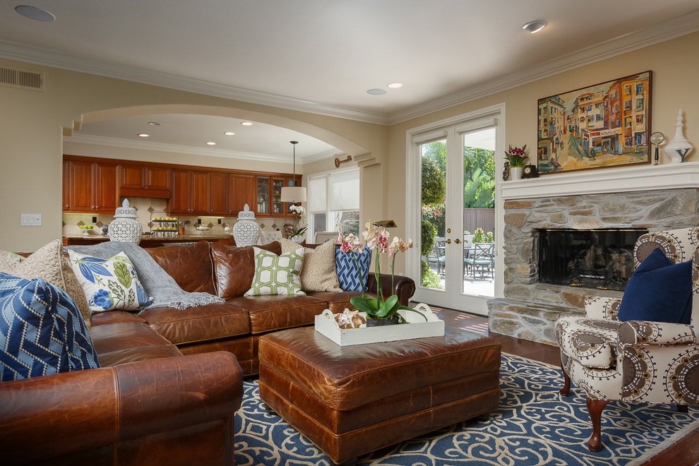 Large transitional open concept dark wood floor family room photo in San Diego with beige walls, a standard fireplace, a stone fireplace and a media wall