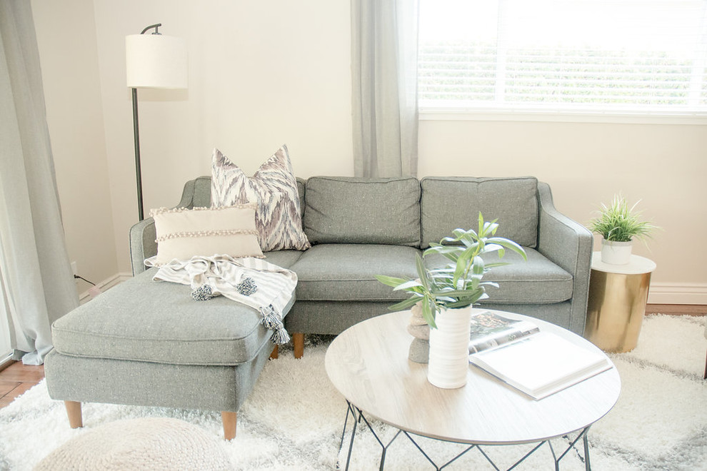 Imagen de sala de estar abierta moderna pequeña con paredes beige, suelo de madera oscura, televisor independiente y suelo marrón