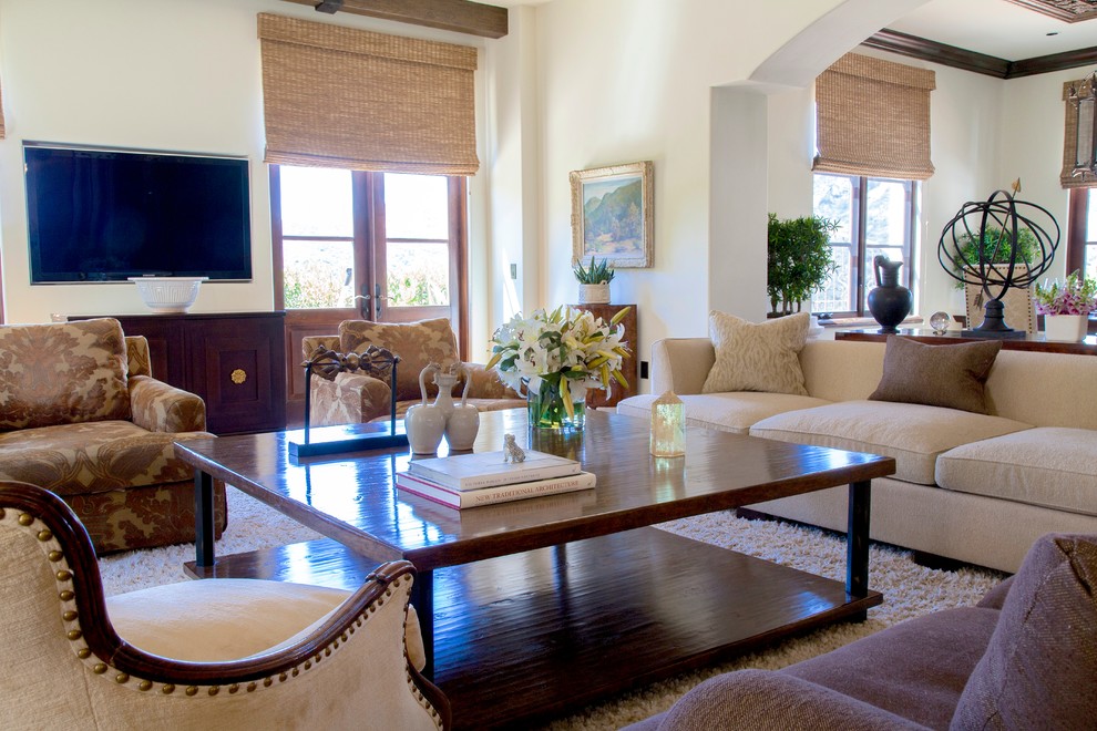 Example of a transitional open concept medium tone wood floor family room design in Los Angeles with white walls and a wall-mounted tv