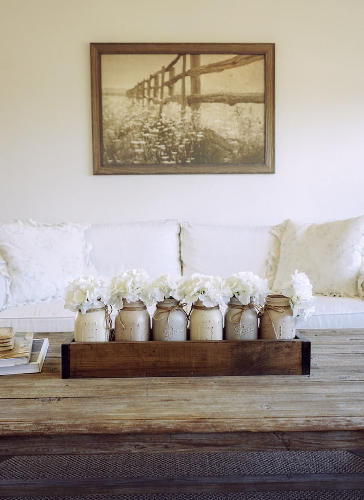 Mid-sized farmhouse enclosed medium tone wood floor and brown floor family room photo in Santa Barbara with white walls, no fireplace and a tv stand