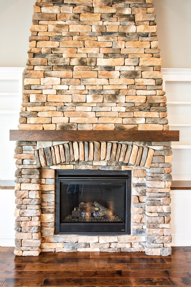 Inspiration for a mid-sized craftsman open concept dark wood floor family room remodel in Richmond with gray walls, a standard fireplace, a stone fireplace and a media wall