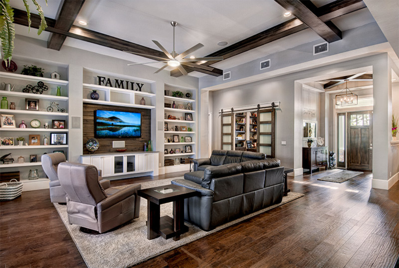 Large traditional open plan games room in Miami with grey walls, dark hardwood flooring, no fireplace and a wall mounted tv.