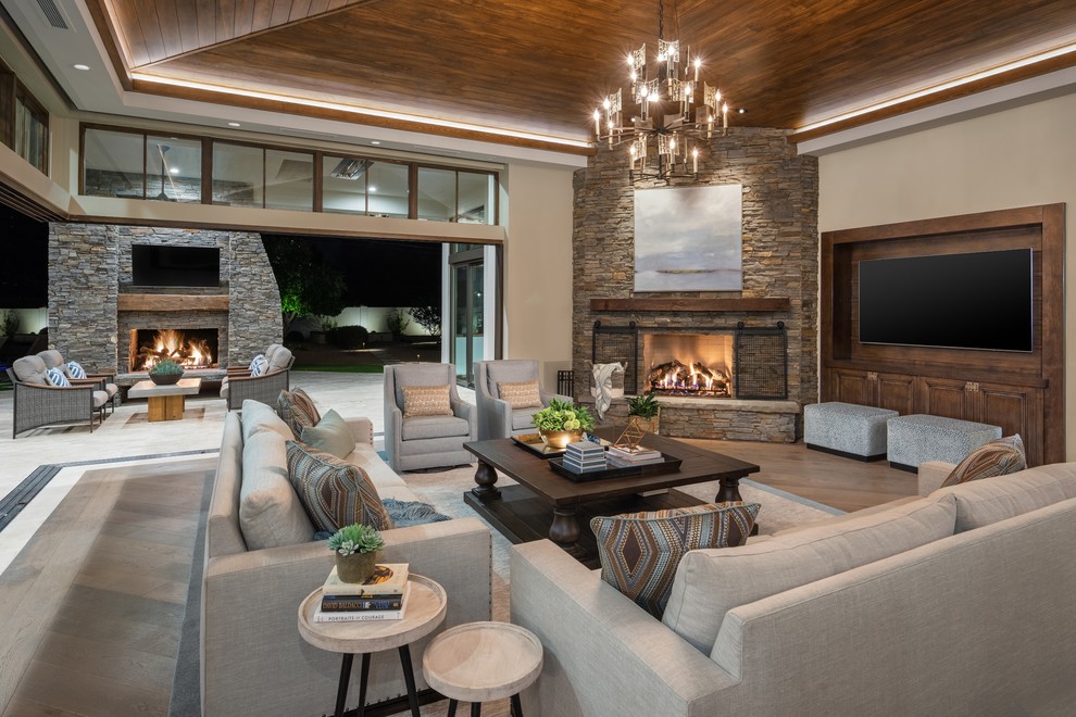 Family room - large contemporary open concept medium tone wood floor and brown floor family room idea in Phoenix with white walls, a corner fireplace, a stone fireplace and a media wall